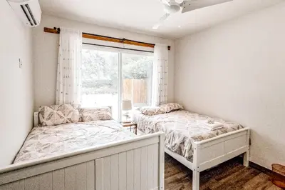 a bedroom with two beds and a window at Casa El Sueño in Brasilito
