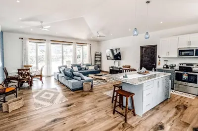 a kitchen and living room with a couch and a table at Casa El Sueño in Brasilito