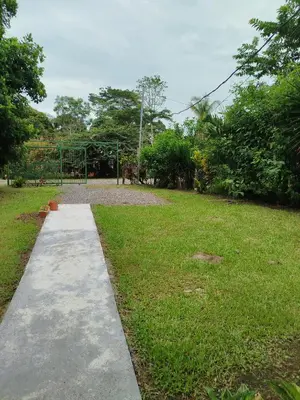 a path in a park with a grass field at Paraíso Verde in Siquirres