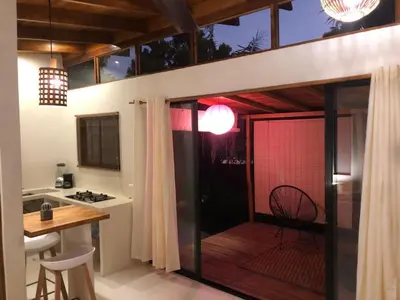 a kitchen with a balcony with a table and a dining room at Hotel Luz de Luna in Santa Teresa Beach