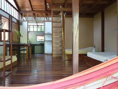 a room with a bunk bed and a desk at Hotel Luz de Luna in Santa Teresa Beach
