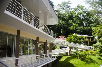a view of a house with white rails and windows at Hotel Arenas en Punta Leona in Jacó