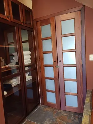 a closet with glass doors in a room at B&B Rosa Dei Venti in Tronadora