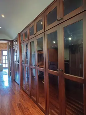 a large wooden cabinet with glass doors in a room at B&B Rosa Dei Venti in Tronadora