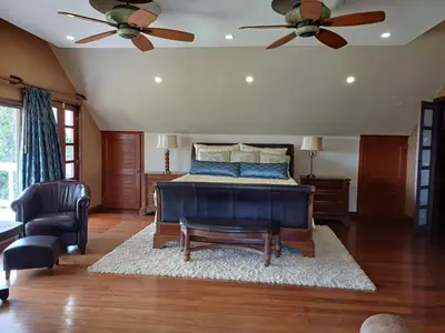 a bedroom with a bed and a ceiling fan at B&B Rosa Dei Venti in Tronadora