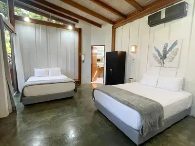 a bedroom with two beds in a room at Fuego Lodge in Santa Teresa Beach