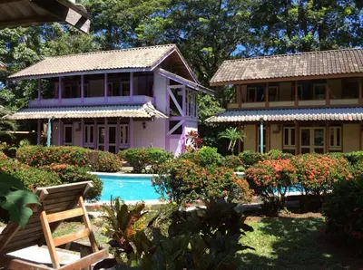 a house with a swimming pool in front of a house at Villas de la Bahia Playa Tambor in Tambor
