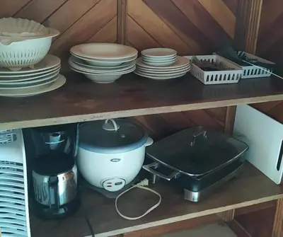 a shelf with plates and bowls and other dishes at Villas de la Bahia Playa Tambor in Tambor