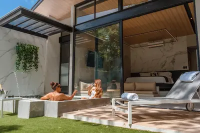 a house with two people in a bathtub at Epic Tamarindo Boutique Hotel in Tamarindo