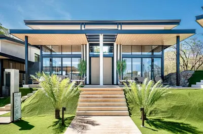 an exterior view of a house with glass doors at Epic Tamarindo Boutique Hotel in Tamarindo