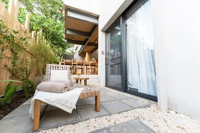 a patio with a chair and a sliding glass door at Alma Tropical - Luxury Villa Experience in Santa Teresa in Santa Teresa Beach