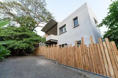 a wooden fence in front of a house at Alma Tropical - Luxury Villa Experience in Santa Teresa in Santa Teresa Beach