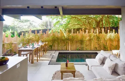 a patio with a pool and a table and chairs at Alma Tropical - Luxury Villa Experience in Santa Teresa in Santa Teresa Beach