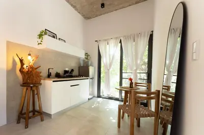 a kitchen with a counter and a table and chairs at Alma Tropical - Luxury Villa Experience in Santa Teresa in Santa Teresa Beach