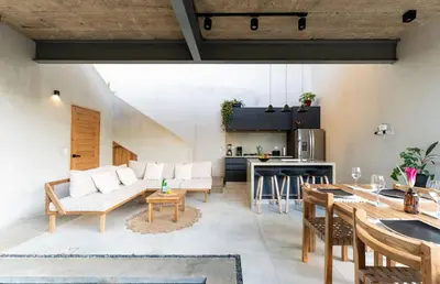 a kitchen and living room with a couch and a table at Alma Tropical - Luxury Villa Experience in Santa Teresa in Santa Teresa Beach