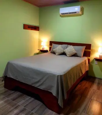 a bedroom with a bed with two pillows on it at Arenal More Apartamento in San Ramón