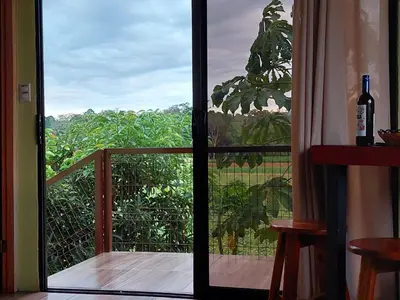 a door leading to a balcony with a view at Arenal More Apartamento in San Ramón