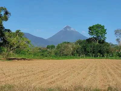 a dirt field with a mountain in the background at Arenal More Apartamento in San Ramón