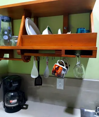 a shelf with utensils on a kitchen counter at Arenal More Apartamento in San Ramón