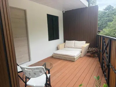 a balcony with a couch and a table and chair at Matata in San Juanillo