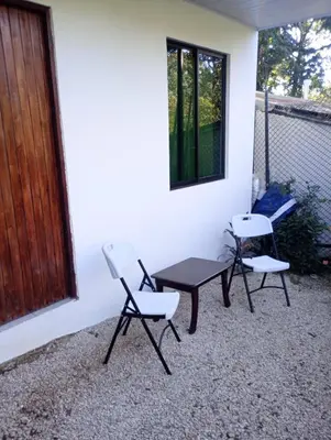 two chairs and a table on a patio at Matata in San Juanillo