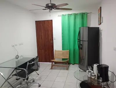a kitchen with a glass table and a refrigerator at Matata in San Juanillo