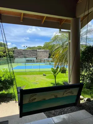 a porch swing with a view of a tennis court at Hidden Paradise Tennis and Pickleball Getaway in Esperanza