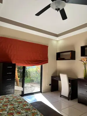 a bedroom with a bed and a desk and a window at Hidden Paradise Tennis and Pickleball Getaway in Esperanza