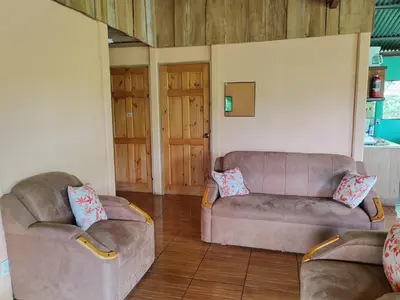 a living room with two couches and a couch at Bella Vista Guest house in Turrialba