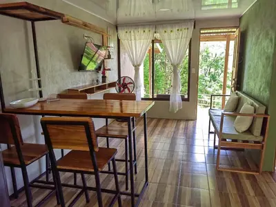 a kitchen with a table and chairs in a room at Papaturro House in La Cruz