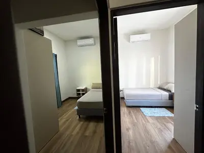 a room with a bed and a bedroom with a mirror at Peaceful Apartment in Tamarindo, 50m to the Beach - Sofia Apartments in Tamarindo