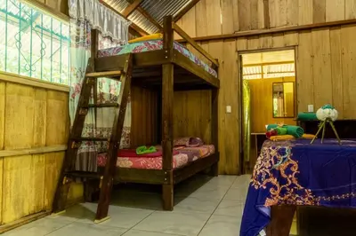 a bedroom with a bunk bed in a room at Los Paniquines Ecolodge in Drake