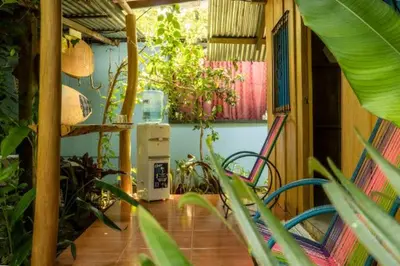 a room with a patio with plants and a heater at Los Paniquines Ecolodge in Drake