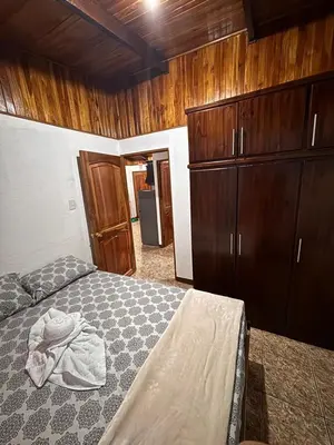 a bedroom with a bed and wooden cabinets at Apartamentos Maily in Fortuna