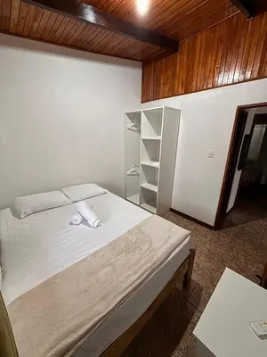 a bedroom with a white bed and a wooden ceiling at Apartamentos Maily in Fortuna