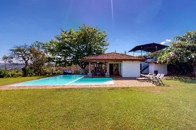 a house with a swimming pool in a yard at Finca de La Luna in Atenas