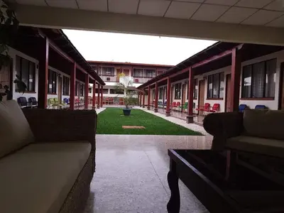 a view of a building with couches and a courtyard at Hotel La Siesta in Liberia