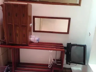 a room with a desk with a tv and a mirror at Hotel El Bramadero in Liberia