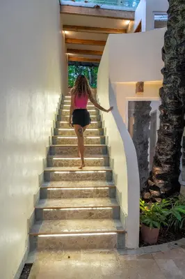 a woman walking up a flight of stairs at Dreamcatcher Hotel - Live the Dream of Santa Teresa in Santa Teresa Beach