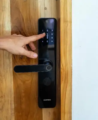 a persons hand presses a remote control on a door at Dreamcatcher Hotel - Live the Dream of Santa Teresa in Santa Teresa Beach