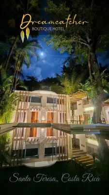 a large building with a pool in front of it at Dreamcatcher Hotel - Live the Dream of Santa Teresa in Santa Teresa Beach
