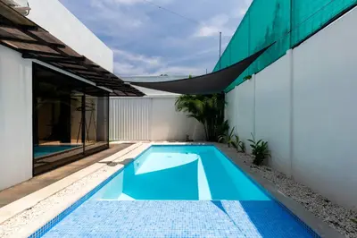 a swimming pool in the backyard of a house at Private pool & rooftop patio Hot tub, AC, WI-FI in Jacó