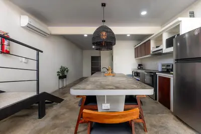 a kitchen with a table and chairs in a room at Private pool & rooftop patio Hot tub, AC, WI-FI in Jacó