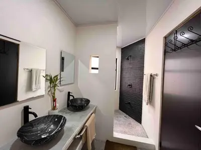 a bathroom with a sink and a shower at Private pool & rooftop patio Hot tub, AC, WI-FI in Jacó