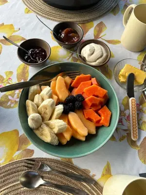 a plate of fruit and vegetables on a table at Casa Monte Armadillo in Poás