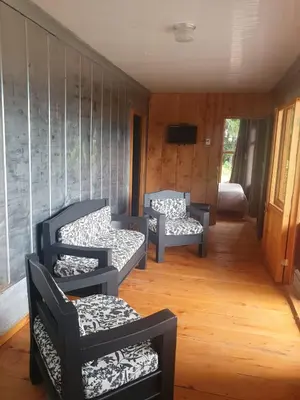 a living room with two chairs and a couch at Casa Monte Armadillo in Poás