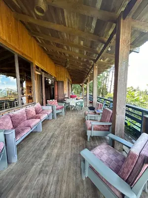 a waiting room with pink couches and tables at Casa Monte Armadillo in Poás