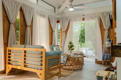 a living room with a couch and a chair at Casa Choucoune in Parrita