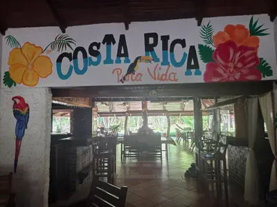 a restaurant with a sign that reads costa ricanaja village at Lodge Barka Lounge in Jabilla