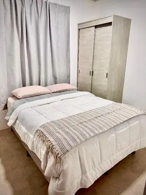 a bedroom with a large bed with a window at Celajes del Poás in Poás